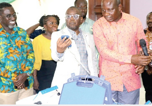 Alhaji Hafiz Adam (2nd from right) examining one of the devices