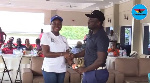 Gifty Appiah presenting a trophy to one of the winners