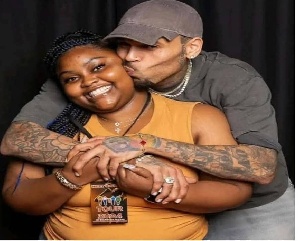 The photo showed Brown hugging her from behind and kissing her cheek.