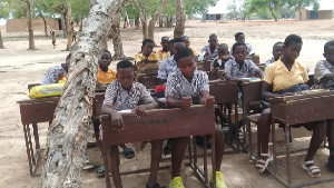 The 55 pupils and their tutors take their lessons under trees despite the heat produced