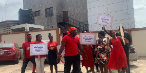 Dressed in red and holding placards, they voiced their concerns about the environmental destruction