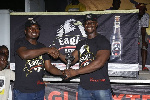 John Akada (left) presenting a trophy to one of the winners