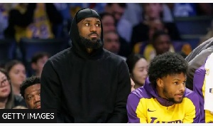 LeBron James (left) was on the bench with son Bronny against the Portland Trail Blazers