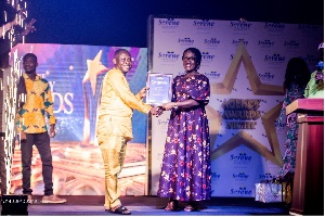 Kofi Senya, the national overall best agent for 2024, receiving a citation from Mrs. Boampong