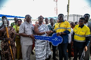 Kwaku Bediako is handing over the key of the community library to the traditional ruler
