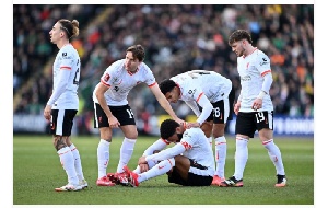 Joe Gomez of Liverpool reacts on the floor