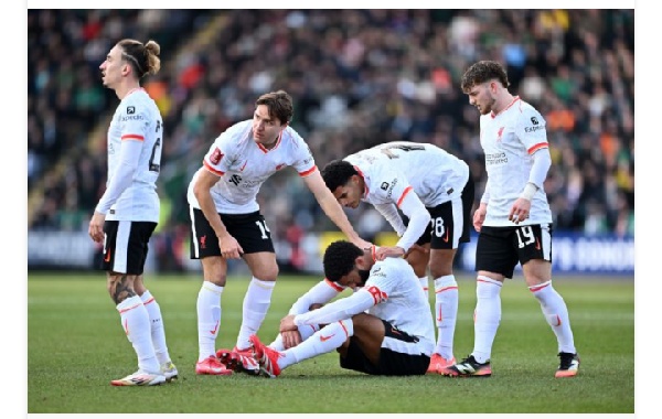 Joe Gomez of Liverpool reacts on the floor