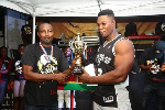 President of GAF, Charles Osei Assibey presenting the giant trophy to Derrick Kwakye