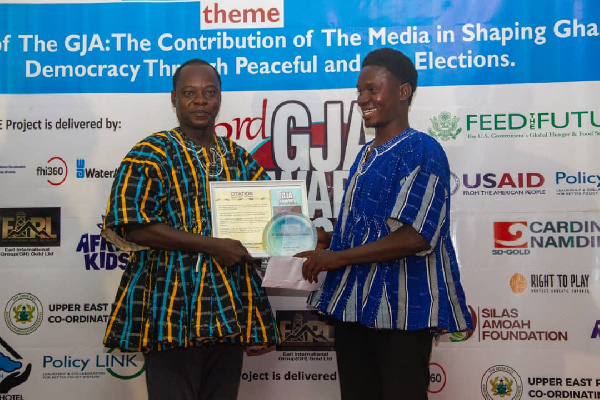 Moses Apiah receiving a citation on the awards night