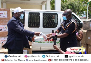 Chairman and CEO of Goldstar Air Eric Bannerman, presenting assorted items