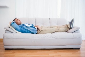 man-laying-on-couch-enjoyin cold air time.