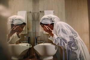 woman washing her face
